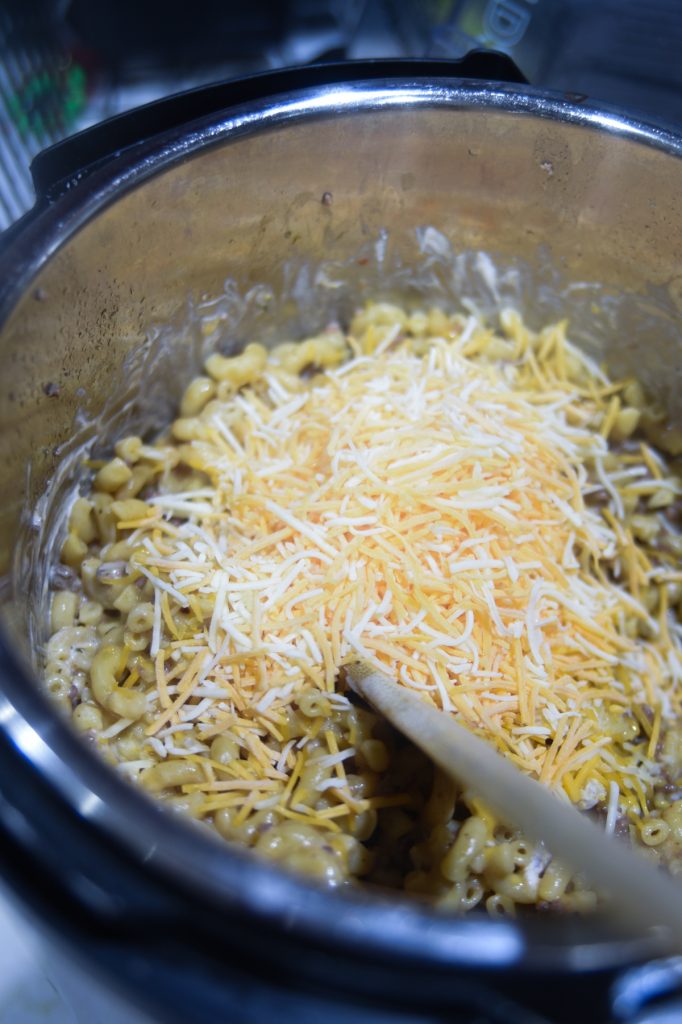 stirring cheese in with pasta